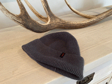 Load image into Gallery viewer, Grey beanie resting on cabinet 